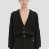 Cardigan con bolsillos trenzados en negro Cardigan con bolsillos trenzados en negro